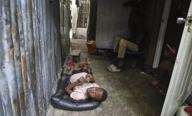 People displaced by gang violence live at the Ministry of Public Works, Transport and Communications office converted into a shelter in Port-au-Prince, Haiti, Tuesday, Sept. 9, 2025. (AP Photo/Odelyn Joseph)