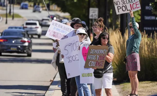 Protesters picket near the U.S. Immigration and Customs Enforcement regional field office, Thursday, Sept. 11, 2025, in Burlington, Mass. (AP Photo/Charles Krupa)