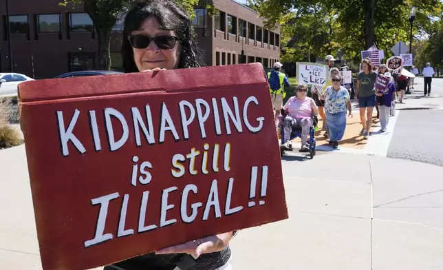 Protesters picket near the U.S. Immigration and Customs Enforcement regional field office, Thursday, Sept. 11, 2025, in Burlington, Mass. (AP Photo/Charles Krupa)