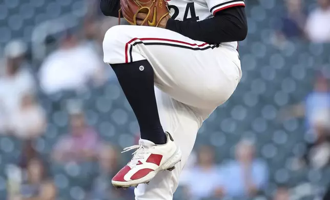 CORRECTS TO TWINS PITCHER SIMEON WOODS RICHARDSON NOT YANKEES PITCHER CARLOS RODON - Minnesota Twins pitcher Simeon Woods Richardson winds up to throw against the New York Yankees during the first inning of baseball game Monday, Sept. 15, 2025, in Minneapolis. (AP Photo/Matt Krohn) Simeon Woods Richardson