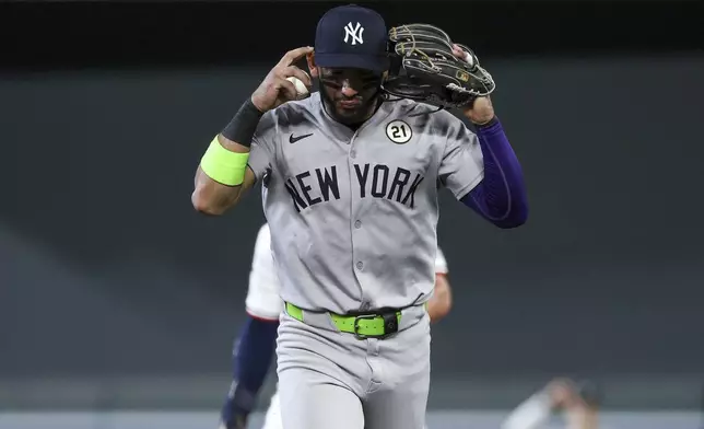New York Yankees shortstop José Caballero gestures for a review during the sixth inning of baseball game against the Minnesota Twins, Monday, Sept. 15, 2025, in Minneapolis. (AP Photo/Matt Krohn)