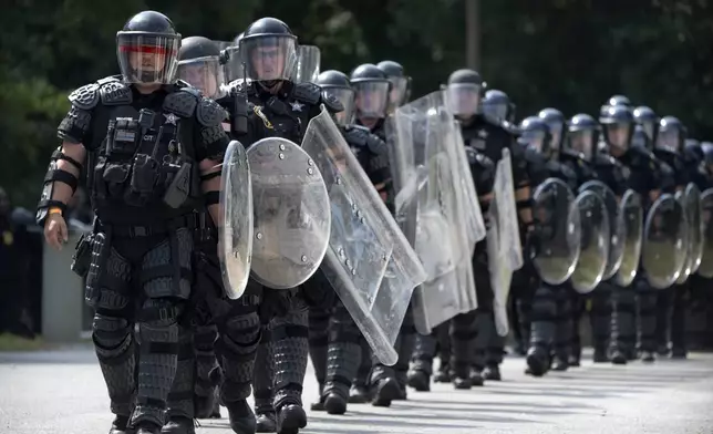 During a training exercise involving local and federal law enforcement organized by the U.S. Capitol Police, police officers wearing protective equipment march at the U.S. Secret Service James J. Rowley Training Center Friday, Sept. 5, 2025, in Laurel, Md. (AP Photo/Mark Schiefelbein)