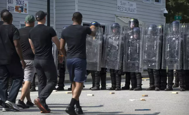 During a training exercise involving local and federal law enforcement organized by the U.S. Capitol Police, people confront police officers wearing protective equipment at the U.S. Secret Service James J. Rowley Training Center Friday, Sept. 5, 2025, in Laurel, Md. (AP Photo/Mark Schiefelbein)