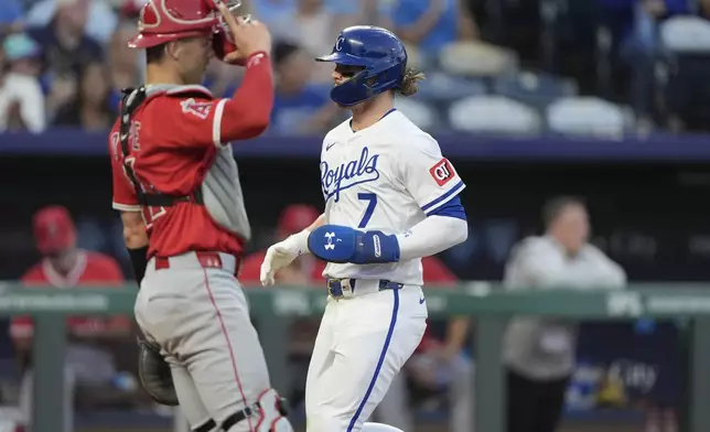 Kansas City Royals' Bobby Witt Jr. (7) crosses the plate past Los Angeles Angels catcher Logan O'Hoppe to score on a sacrifice fly by Vinnie Pasquantino during the third inning of a baseball game Tuesday, Sept. 2, 2025, in Kansas City, Mo. (AP Photo/Charlie Riedel)