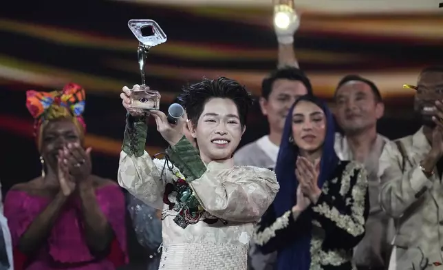 Vietnam's Duc Phuc holds his trophy after winning the International Music Competition "Intervision" at the Live Arena outside Moscow, Russia, Sunday, Sept. 21, 2025. (AP Photo/Alexander Zemlianichenko)