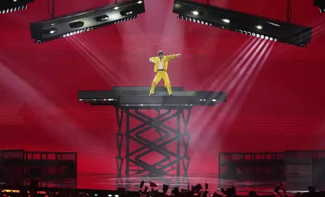 Tajikistan's Farrukh Hasanov performs the song "Burn!" at the International Music Competition "Intervision" at the Live Arena outside Moscow, Russia, Saturday, Sept. 20, 2025. (AP Photo/Alexander Zemlianichenko)