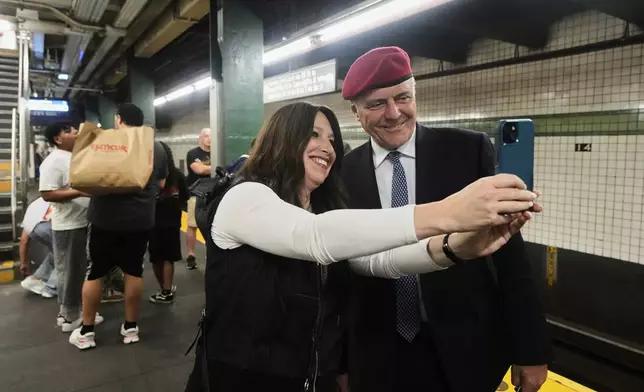New York Mayor candidate Curtis Sliwa poses for a photo with a woman as he campaigns in the New York City subway system, Monday, Aug. 18, 2025. (AP Photo/Richard Drew)