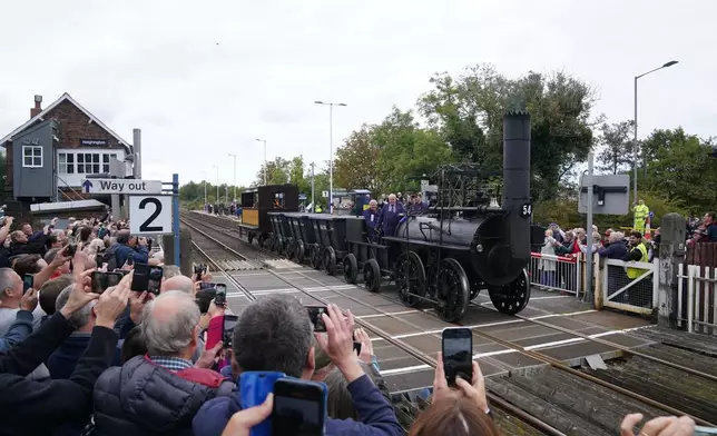 Replica Locomotion No1 passes through Heighington, County Durham, Friday, Sept. 26, 2025, on its first official journey in 200 years from the Locomotion Museum in Shildon to Darlington, as part of celebrations marking the 200th anniversary of British passenger rail services. (Owen Humphreys/PA via AP)