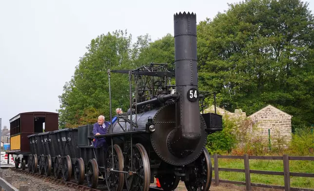 Train driver Chris Cubit on board the Locomotion No 1 replica at the Locomotion Museum in Shildon, County Durham, Friday, Sept. 26, 2025, on its first official journey in 200 years from the Locomotion Museum in Shildon to Darlington, as part of celebrations marking the 200th anniversary of British passenger rail services. (Owen Humphreys/PA via AP)