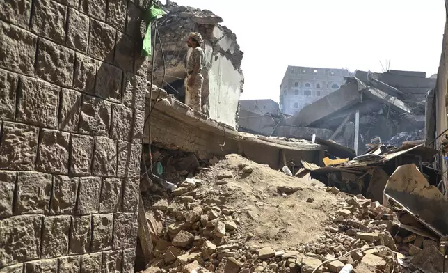 A man inspects damage to buildings following Wednesday's Israeli airstrikes in Sanaa, Yemen, Saturday, Sept. 13, 2025. (AP Photo/Osamah Abdulrahman)