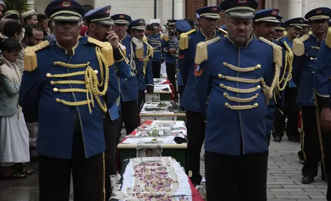 Yemeni honor guards stand beside the coffins of 31 local journalists reportedly killed in Israeli airstrikes last week, during their funeral in Sanaa, Yemen, Tuesday, Sept. 16, 2025. (AP Photo/Osamah Abdulrahman)