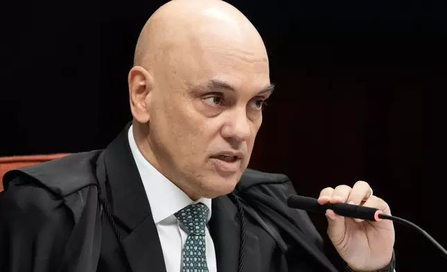 Supreme Court Justice Alexandre de Moraes speaks during the verdict and sentencing phase of a trial for those charged in an alleged coup plot to keep Brazil's former President Jair Bolsonaro in office after his 2022 election defeat, in Brasilia, Brazil, Tuesday, Sept. 2, 2025. (AP Photo/Eraldo Peres)