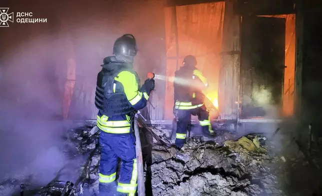 In this photo provided by the Ukrainian Emergency Service, firefighters put out the fire following a Russian missile attack in Tatarbunary, Odesa region, Ukraine, Tuesday, Sept. 23, 2025. (Ukrainian Emergency Service via AP)