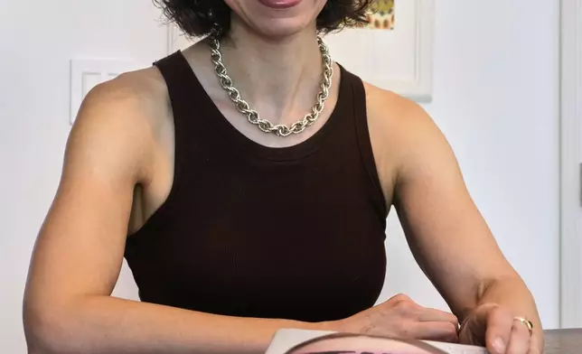 Thriller novelist Andrea Bartz is photographed in her home, in the Brooklyn borough of New York, Thursday, Sept. 4, 2025 (AP Photo/Richard Drew)