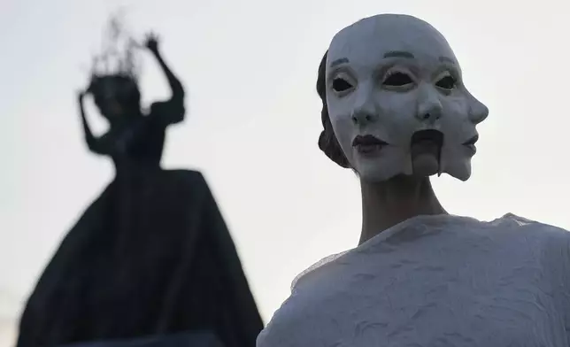 A model wears a creation by Russian brand Mandragora on a runway at the Moscow Fashion Week on the Floating Bridge at Zaryadye park in Moscow, Russia, Friday, Aug. 29, 2025. (AP Photo/Pavel Bednyakov)