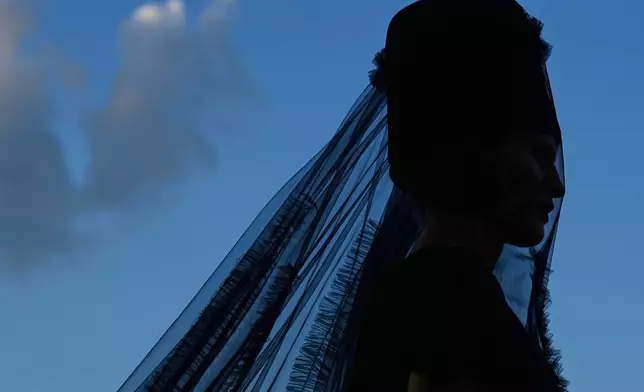 A model wears a creation by Russian designer Alexander Arutyunov on a runway at Moscow Fashion Week on the Floating Bridge at Zaryadye park in Moscow, Russia, Thursday, Aug. 28, 2025. (AP Photo/Pavel Bednyakov)