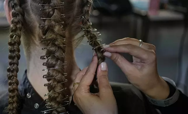 A model is prepared for a runway show at the backstage of the Moscow Fashion Week in Moscow, Russia, Friday, Aug. 29, 2025. (AP Photo/Pavel Bednyakov)