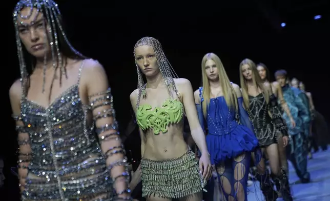 Models wear creations by Brazilian brand Artemisi on a runway at the Moscow Fashion Week in Moscow, Russia, Friday, Aug. 29, 2025. (AP Photo/Pavel Bednyakov)