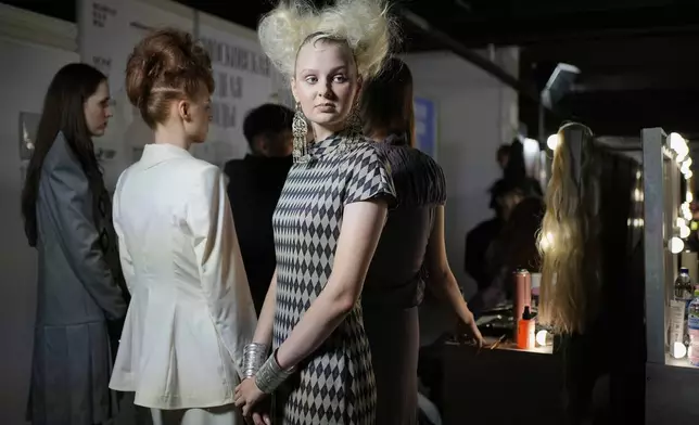 Models are prepared for a runway show at the backstage of the Moscow Fashion Week in Moscow, Russia, Friday, Aug. 29, 2025. (AP Photo/Pavel Bednyakov)