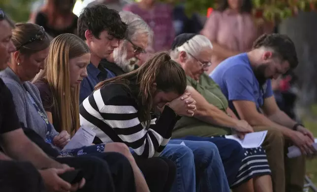Attendees react during a vigil at Spring Grove Alliance church Thursday, Sept. 18, 2025, in Spring Grove, Pa., after multiple police officers were shot and killed. (AP Photo/Matt Slocum)