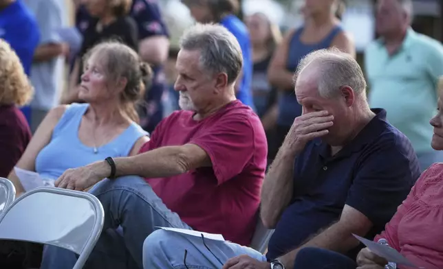 Attendees react during a vigil at Spring Grove Alliance church Thursday, Sept. 18, 2025, in Spring Grove, Pa., after multiple police officers were shot and killed. (AP Photo/Matt Slocum)