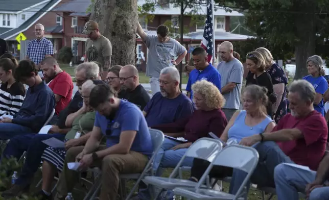 Attendees react during a vigil at Spring Grove Alliance church Thursday, Sept. 18, 2025, in Spring Grove, Pa., after multiple police officers were shot and killed. (AP Photo/Matt Slocum)