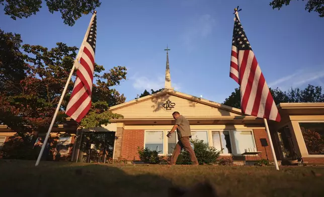 An attendee walks outside Spring Grove Alliance church before a vigil Thursday, Sept. 18, 2025, in Spring Grove, Pa., after multiple police officers were shot and killed. (AP Photo/Matt Slocum)