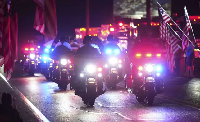 Police officers ride during a procession Wednesday, Sept. 17, 2025, in Spring Grove, Pa., after multiple police officers were shot and killed. (AP Photo/Matt Slocum)