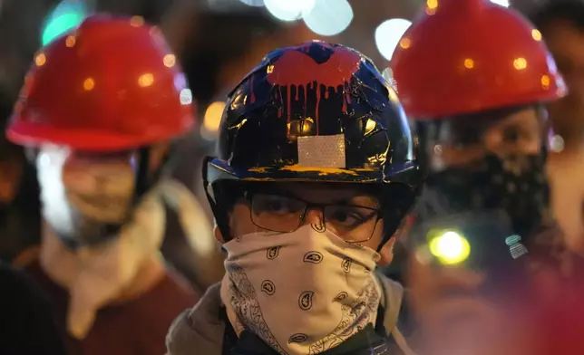 People stand in silence to commemorate the victims, killed after a railway concrete canopy fell in November 2024 during a protest against increasing police brutality in the northern Serbian city of Novi Sad, Friday, Sept. 5, 2025. (AP Photo/Darko Vojinovic)