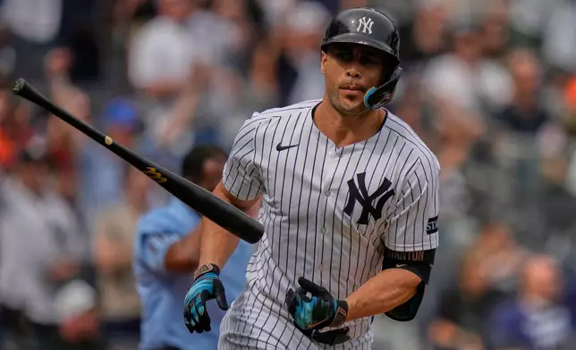 New York Yankees' Giancarlo Stanton tosses his bat after hitting a home run during the second inning of a baseball game against the Baltimore Orioles Saturday, Sept. 27, 2025, in New York. (AP Photo/Frank Franklin II)