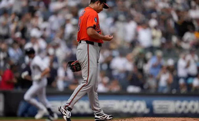 Baltimore Orioles pitcher Tomoyuki Sugano, right, reacts as New York Yankees' Ryan McMahon runs the bases after hitting a home run during the second inning of a baseball game Saturday, Sept. 27, 2025, in New York. (AP Photo/Frank Franklin II)