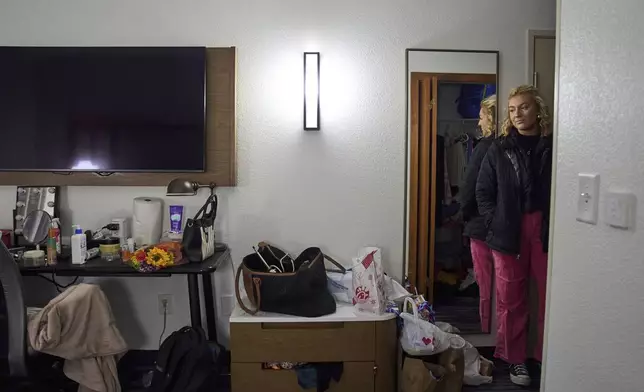 Gwendolyn Bode looks at the hotel room where she is temporarily living in Boone, N.C., on Thursday, Dec. 5, 2024, after being displaced from her apartment that was damaged during Hurricane Helene. (AP Photo/Stephanie Scarbrough)