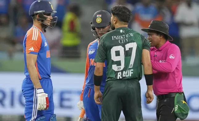 Umpire mediates between Indian players Abhishek Sharma, Shubman Gill and Haris Rauf during the Asia Cup cricket match between India and Pakistan at Dubai International Cricket Stadium, United Arab Emirates, Sunday, Sept. 21, 2025. (AP Photo/Altaf Qadri)