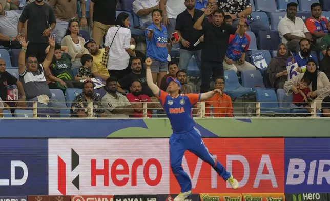 Spectators react as India's Abhishek Sharma drops the catch of Pakistan's Sahibzada Farhan during the Asia Cup cricket match between India and Pakistan at Dubai International Cricket Stadium in Dubai, United Arab Emirates, Sunday, Sept. 21, 2025. (AP Photo/Altaf Qadri)