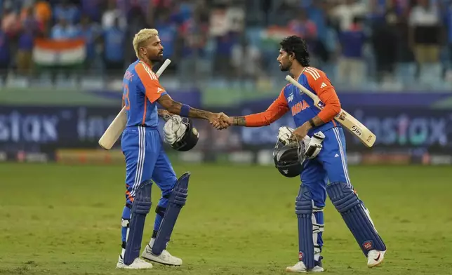India's Hardik Pandya and Tilak Varma shake hands after wining during the Asia Cup cricket match against Pakistan at Dubai International Cricket Stadium, United Arab Emirates, Sunday, Sept. 21, 2025. (AP Photo/Altaf Qadri)
