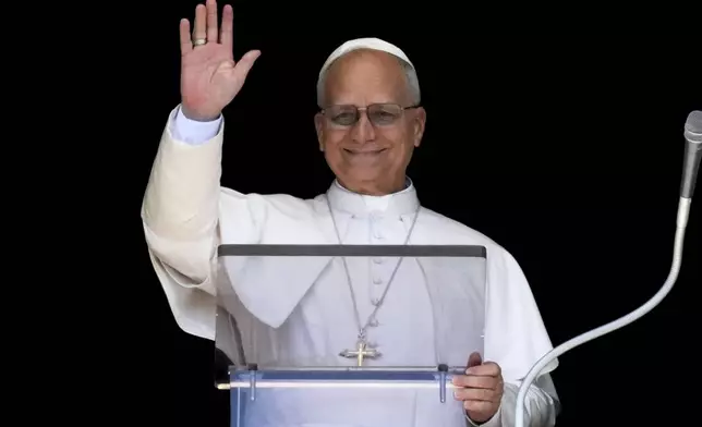 Pope Leo XIV delivers his blessing as he recites the Angelus noon prayer from the window of his studio overlooking St.Peter's Square, at the Vatican, Sunday, Aug. 31, 2025. (AP Photo/Andrew Medichini)
