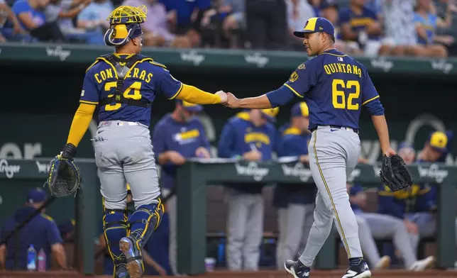Milwaukee Brewers starting pitcher Jose Quintana (62) and catcher William Contreras (24) react after pitching to the Texas Rangers during the first inning of a baseball game Monday, Sept. 8, 2025, in Arlington, Texas. (AP Photo/Julio Cortez)