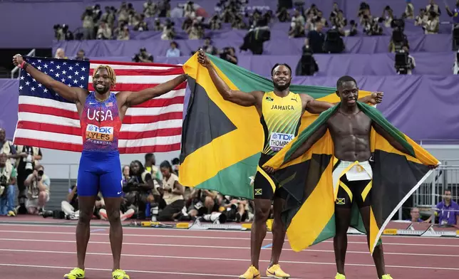 Jamaica's gold medalist Oblique Seville, right, and silver medalist Kishane Thompson, pose with bronze medalist United States' Noah Lyles, left, after competing in the men's 100 meters final at the World Athletics Championships in Tokyo, Sunday, Sept. 14, 2025. (AP Photo/Matthias Schrader)