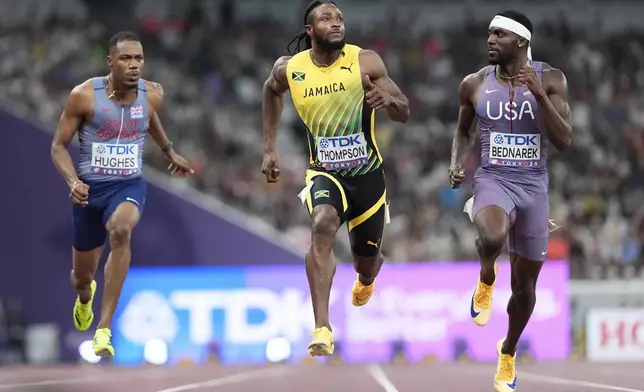 United States' Kenneth Bednarek, Jamaica's Kishane Thompson and Britain's Zharnel Hughes race in a men's 100 meters semifinal at the World Athletics Championships in Tokyo, Sunday, Sept. 14, 2025. (AP Photo/Petr David Josek)