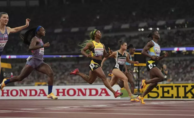 Jamaica's Shelly-Ann Fraser-Pryce (5) runs in a women's 100 meters semifinal at the World Athletics Championships in Tokyo, Sunday, Sept. 14, 2025. (AP Photo/Bernat Armangue)