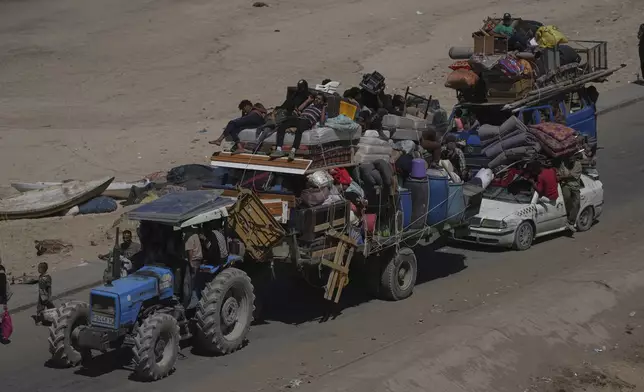 Displaced Palestinians flee northern Gaza Strip, by foot and in vehicles, carrying their belongings along the coastal road, near Wadi Gaza, Saturday, Sept. 20, 2025. (AP Photo/Abdel Kareem Hana)