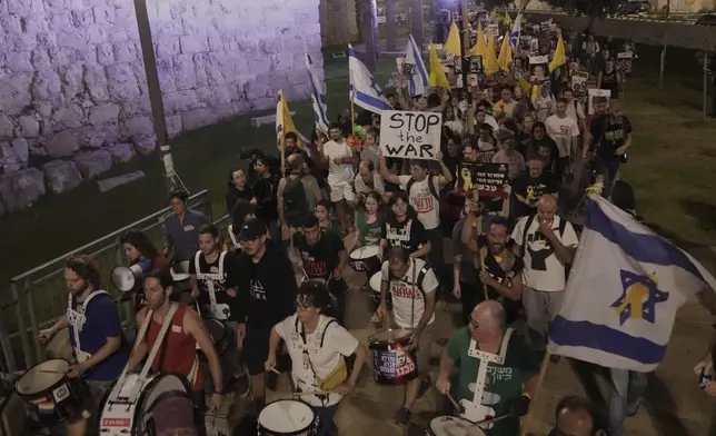 Relatives and supporters of Israeli hostages held in the Gaza Strip take part in a protest demanding their release from Hamas captivity and calling for an end to the war, outside the Old City of Jerusalem, Saturday, Sept. 20, 2025. (AP Photo/Mahmoud Illean)