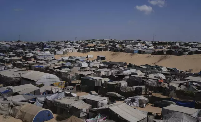 A tent camp for displaced Palestinians stretches along the Muwasi, an area that Israel has designated as a safe zone, in Khan Younis southern Gaza Strip, Sunday, Sept. 21, 2025. (AP Photo/Jehad Alshrafi)