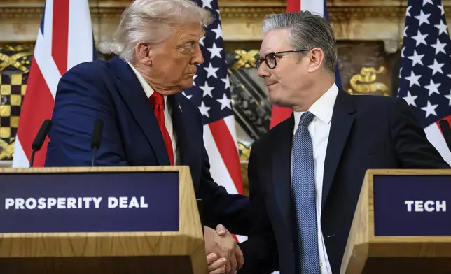 U.S. President Donald Trump, left, and British Prime Minister Keir Starmer look at each other as they shake hands during a press conference at Chequers near Aylesbury, England, Thursday Sept. 18, 2025, at the conclusion of President Trump's second UK state visit, with the previous one taking place in 2019 during his first presidential term. (Leon Neal/Pool Photo via AP)