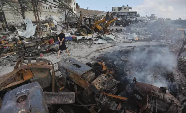 A Lebanese man inspects the site where Israeli airstrikes on Wednesday night hit bulldozers in Ansariyeh village, south Lebanon, Thursday, Sept. 4, 2025. (AP Photo/Mohammed Zaatari)