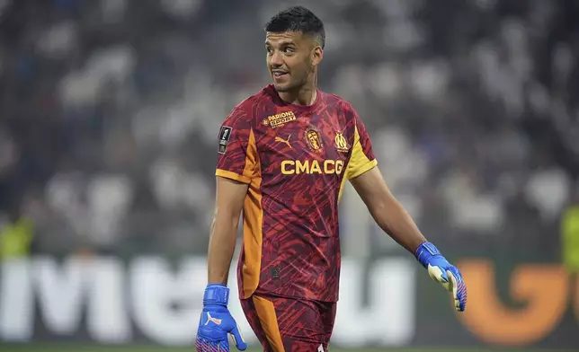 Marseille's goalkeeper Geronimo Rulli smiles during the French League One soccer match between Lyon and Marseille, in Decines, outside Lyon, France, Sunday, Aug. 31, 2025. (AP Photo/Laurent Cipriani)