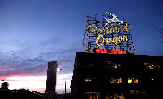 FILE - The "Portland, Oregon" sign is seen atop in building in downtown Portland, Ore., Jan. 27, 2015. (AP Photo/Don Ryan, File)