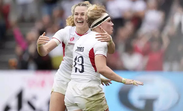 England's Megan Jones, right, celebrates scoring a try during the Women's Rugby World Cup 2025 semifinal match between France and England at Ashton Gate, in Bristol, England, Saturday Sept. 20, 2025. (Andrew Matthews/PA via AP)