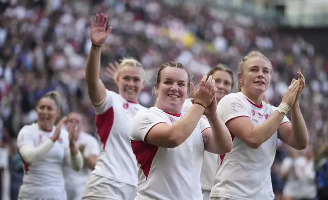 England players celebrate after defeating France during the Women's Rugby World Cup 2025 semifinal match between France and England in Bristol, England, Saturday, Sept. 20, 2025.(AP Photo/Alastair Grant)