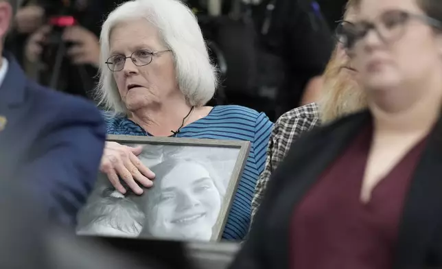 Debbie Dennison, grandmother to murder victim James Matthew Wilson, holds a portrait in court during a preliminary hearing for Austin Drummond, who is accused of quadruple murder, Thursday, Sept. 4, 2025, in Tiptonville, Tenn. (AP Photo/George Walker IV, Pool)